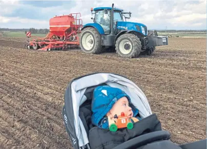  ?? Photograph by Kami Thomson ?? LAYING GROUNDWORK: The next generation looks on as spring sowing begins.