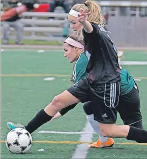  ??  ?? Colonel Gray’s Emma Moore, foreground, and Three Oaks’ Savanah Arsenault battle for the ball during Prince Edward Island School Athletic Associatio­n senior girls AAA soccer semifinal action Wednesday in Cornwall.