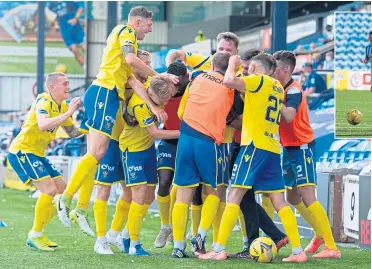  ??  ?? Michael O’Halloran is mobbed by his team-mates after netting in stoppage time