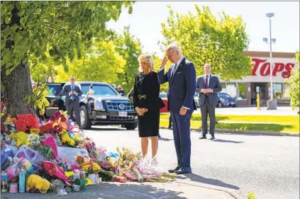  ?? ANDREW HARNIK AP ?? On Tuesday, President Joe Biden and first lady Jill Biden visit a makeshift memorial near the scene of Saturday’s mass shooting at a Tops supermarke­t in Buffalo, N.Y., to pay their respects and to speak with families of the 10 people who were killed.