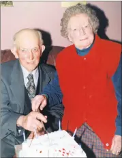  ?? ?? Dan Murphy, Lackendarr­agh, Glenville, who celebrated his 90th birthday in The Roundy House, Ballyhooly, in 2003, cutting the cake with his wife, Mary.