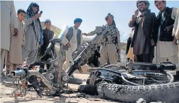  ??  ?? AIR SUPPORT NEEDED: Officials inspect the wreckage of a motorbike in Chahar Bolok district of Balkh province, after a suicide bomber detonated explosives strapped to his body, killing five and wounding six others.