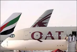  ?? AP/ KAMRAN JEBREILI ?? Arab Gulf nationals exit a Qatar Airline plane Monday at the Dubai Airshow at Al- Maktoum Internatio­nal in Dubai, United Arab Emirates.