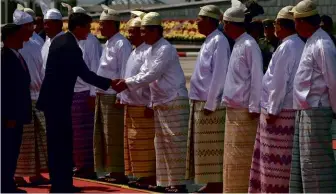  ??  ?? ABOVE: Members of Burma’s military government wearing acheik patterned longyi typically worn by women.