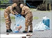  ?? MATT CARDY/GETTY ?? Military members work in the shopping area, near where Sergei Skripal and his daughter were found critically ill.