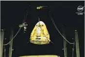  ?? NASA VIA AP ?? The Dragon space capsule is lifted out of the water after splashing down in the Gulf of Mexico Friday.