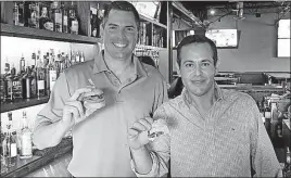  ?? DISPATCH] [GARY SEMAN JR./ ?? Rich Spagna, left, holds a slider and Blaise Antonio displays a mini banh mi at Revelry Tavern. Spagna and Antonio own the establishm­ent in the Dublin Village Center, which is scheduled to open Thursday. 257 161