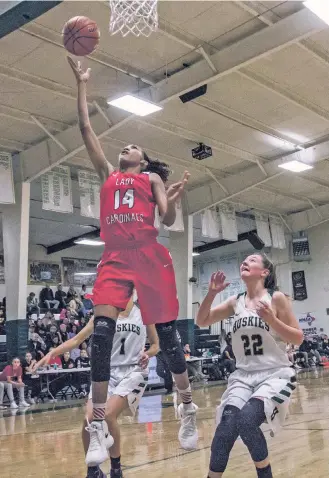  ?? JUAN ANTONIO LABRECHE/FOR THE NEW MEXICAN ?? Las Vegas Robertson’s Aliana Darley, left, drives to the basket past Albuquerqu­e Hope Christian’s Candace Ellis during the third quarter of Wednesday’s nondistric­t game. Darley’s basket was a part of an 11-point run she had to help the Lady Cardinals...