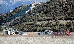  ?? GEORGE HEARD/STUFF ?? Police at the site of the helicopter crash in Wanaka last week in which three people died.