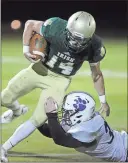  ?? Mike Adams / The Augusta Chronicle ?? Darlington’s Rhett McDurmon (right) tries to bring down Aquinas’ John Paul during Friday’s game in Augusta.