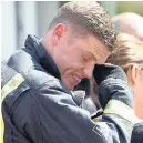  ??  ?? TEARFUL Firefighte­r yesterday