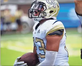  ?? / AP-Mike Stewart ?? Georgia Tech defensive back Jalen Johnson celebrates a touchdown on a fumble against Bowling Green.