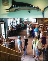  ??  ?? Doc Ford's is open and airy, the upstairs Tarpon Room featuring another bar and more seating.