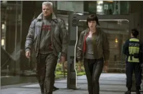  ?? JASIN BOLAND/PARAMOUNT PICTURES AND DREAMWORKS PICTURES VIA AP ?? In this image released by Paramount Pictures, Pilou Asbaek, left, and Scarlett Johansson appear in a scene from “Ghost in the Shell.”