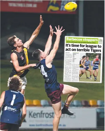  ?? Picture: BRENDAN RADKE ?? BATTLING: Tigers' Brock Wollin and Lions' Tyrone Rainbird leap for a mark in the AFL Cairns match between the Cairns City Lions and the North Cairns Tigers, held at Cazalys.