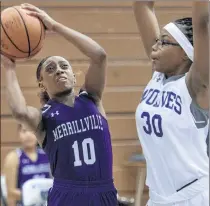  ?? MICHAEL GARD/POST-TRIBUNE ?? Merrillvil­le’s Cailynn Dilosa, left, shoots over Michigan City’s Ashanti Sanders during their game Tuesday at Michigan City.