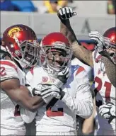  ?? Eric Risberg Associated Press ?? ADOREE’ JACKSON, center, is congratula­ted by teammates after his 46-yard intercepti­on return for a touchdown in the third quarter.