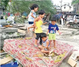  ?? SUNSTAR FOTO / ARNI ACLAO ?? DEMOLITION. Kids play on an abandoned mattress in a demolition site in Sitio Sta. Cruz, Barangay Capitol Site, Cebu City. The demolition became controvers­ial after a confrontat­ion between court sheriff El Cid Caballes and Cebu City Mayor Tomas Osmeña.