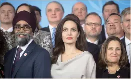  ??  ?? Angelina Jolie, center, stands between Canadian Defense Minister Harjit Sajjan, left, and Minister of Foreign Affairs Chrystia Freeland at the 2017 United Nations Peacekeepi­ng Defense Ministeria­l conference in Vancouver, on Wednesday. (AP)