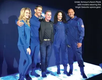  ??  ?? Under Armour’s Kevin Plank
with models wearing the Virgin Galactic space gear.