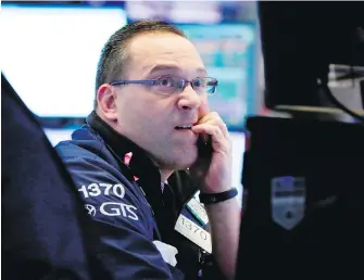  ?? RICHARD DREW, THE ASSOCIATED PRESS ?? Trader Anthony Matesic works on the floor of the New York Stock Exchange during a hectic session Monday. Stocks closed sharply lower on Wall Street as technology companies took heavy losses and investors worried about escalating trade tensions with...
