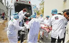  ?? Reuters ?? A patient with breathing problems is wheeled inside a Covid- 19 hospital for treatment in Ahmedabad yesterday.