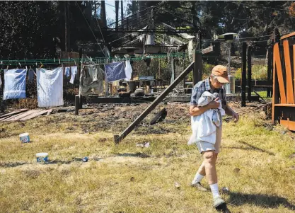  ?? Santiago Mejia / The Chronicle ?? The CZU Lightning Complex that raged in Sonoma County in September damaged the property of a resident of Forestvill­e but left her laundry intact.