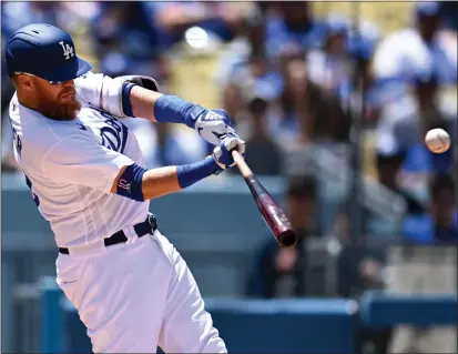  ?? PHOTOS: DAVID CRANE – STAFF PHOTOGRAPH­ER ?? Justin Turner hits a home run, one of the Dodgers’ three in the sixth inning, during the first game of Tuesday’s doublehead­er against Arizona.