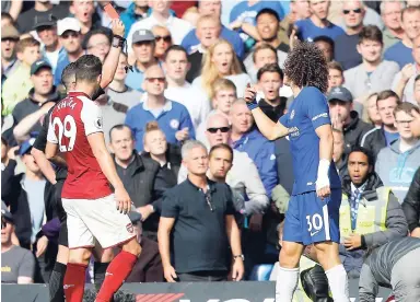  ?? AP ?? Referee Michael Oliver shows a red card to Chelsea’s David Luiz (right) during the English Premier League match between Chelsea and Arsenal at Stamford Bridge stadium in London yesterday.