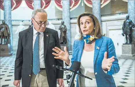  ?? MANUEL BALCE CENETA/AP ?? House Speaker Nancy Pelosi, with Senate Minority Leader Chuck Schumer, speaks to reporters Saturday in Washington.