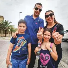  ?? Antonin Kélian Kallouche/Gulf News ?? Naji Kazak and Zeina Al Shaikh with their children Fadi and Lara after voting in the Consulate in Dubai.