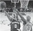  ?? ASSOCIATED PRESS ?? Bucks guard Donte DiVincenz shoots around Lakers guard Dion Waiters on Friday night.