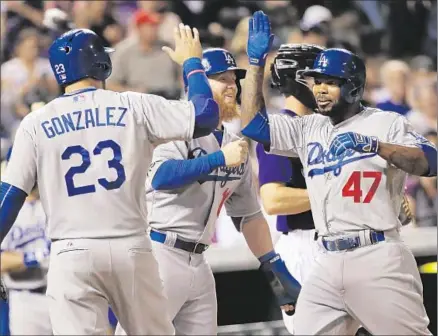  ?? Doug Pensinger
Getty Images ?? HOWIE KENDRICK
(47) celebrates his three-run blast with Adrian Gonzalez and Justin Turner. The Dodgers had four homers.