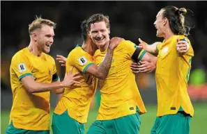  ?? — AP ?? We did it: australia’s Kye rowles (centre) is congratula­ted by teammates after scoring his team’s second goal during the World cup qualifying match against Lebanon.