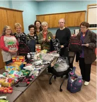  ?? (Special to The Commercial) ?? White Hall Willing Workers EHC stuff backpacks for Neighbor to Neighbor. Participan­ts include Kathy Wilson (from left) Kay Cromwell, Sarah Payton, Tonia Dalby, Jo Ann Carr, Marnette Reed, and Karen Needler.