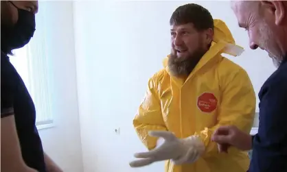  ??  ?? The Chechen leader, Ramzan Kadyrov, dresses in protective clothing during a visit to a Grozny hospital treating coronaviru­s patients. Photograph: Grozny TV Channel/Tass