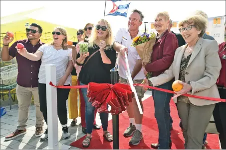  ?? Dan Watson/The Signal ?? (Top) Market Manager Larry McClements, center, joined by dignitarie­s, cut the ribbon at the Canyon Country Farmers Market in Canyon Country.