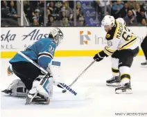  ?? NHAT V. MEYER/STAFF ?? The Bruins’ Brad Marchand scores the game-winning goal against Sharks goaltender Martin Jones with 2:24 remaining in overtime.