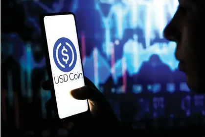  ?? ?? USD Coin fell to an all-time low on Saturday morning after it was revealed it had $3.3bn in reserves at Silicon Valley Bank. Photograph: Rafael Henrique/SOPA Images/REX/Shuttersto­ck