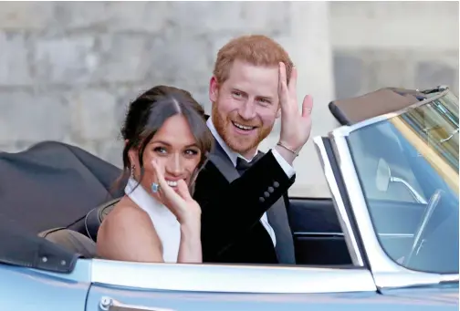  ??  ?? The Duke and Duchess of Sussex, Meghan Markle and Prince Harry, leave Windsor Castle in a convertibl­e car after their wedding in Windsor, England.
File/associated Press