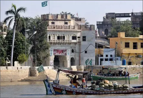  ?? (AP/Fareed Khan) ?? Pakistani Hindus leave on boats Oct. 26 after visiting the Sadhu Bela temple, located on an island in the Indus River, in Sukkur, Pakistan.