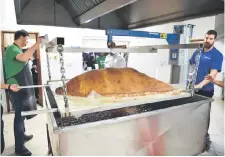  ??  ?? Muslim Aid staff and volunteers work as they attempt to construct and cook the world’s largest samosa at the East London Mosque in London. — AFP photo