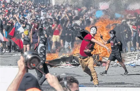  ??  ?? KEEPING UP THE FIGHT: People demonstrat­e at Plaza Italia in Santiago, Chile as police tried to use water cannons and tear gas to disperse demonstrat­ors.