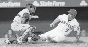  ?? Alex Gallardo / Associated Press ?? Astros catcher Jason Castro, left, tags out the Angels’ Albert Pujols as he tries to score from third on a grounder in the sixth inning.