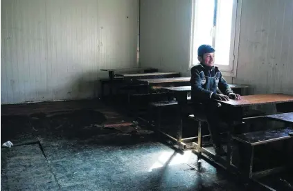  ?? Dimitar Dilkoff / AFP ?? An Iraqi attends school in Mosul’s eastern Gogjali neighbourh­ood. With government forces recently liberating the area from ISIL militants, scores of schools have reopened after being closed for two-and-a-half years because of the occupation.