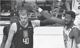  ?? ROBERT HANASHIRO/USA TODAY SPORTS ?? Clippers guard Reggie Jackson, from left, center Ivica Zubac and Suns center Deandre Ayton react to a call in the second quarter of Thursday night’s game at Staples Center in Los Angeles. The Clippers won 113-103.