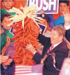  ?? DEAN HANSON/JOURNAL ?? Former President Ronald Reagan displays a chile ristra during a visit to Roswell while campaignin­g for George H.W. Bush in 1992. He also made a stop in Roswell in 1982 to campaign for then-Sen. Harrison Schmitt.