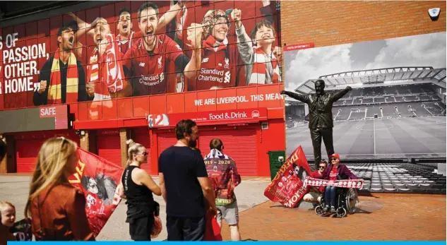  ?? — AFP ?? LIVERPOOL: Liverpool fans gather in celebratio­n outside Anfield stadium in Liverpool, north west England on June 26, 2020 after Liverpool FC sealed the Premier League title the previous evening. Liverpool were crowned Premier League champions without kicking a ball.