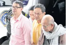  ?? APICHART JINAKUL ?? Former National Office of Buddhism director Phanom Sornsilp, second from right, is apprehende­d along with other suspects on Wednesday.