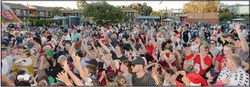  ??  ?? The large crowd scrambled to catch Santa’s lollies.